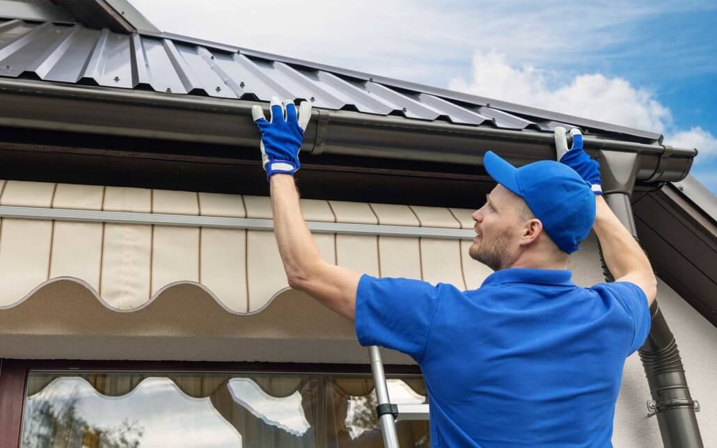 Man putting residential gutter in place