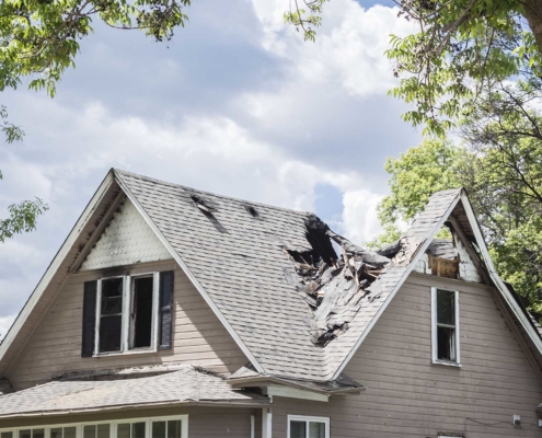 home with a caved in roof due to severe storm damage